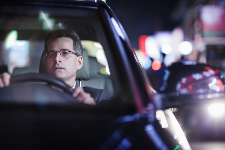 Man driving at night with glasses